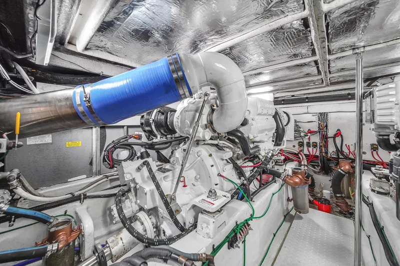 Slide: The Image of Engine room of a 2007 Sea Ray 52 Sedan Bridge yacht, showcasing complex machinery and wiring. - 70