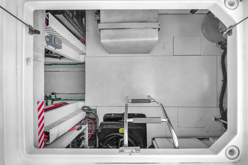 Slide: The Image of Engine room of a 2007 Sea Ray 52 Sedan Bridge yacht, featuring equipment and access ladder. - 74