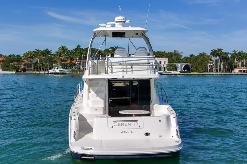 Slide: The Image of 2007 Sea Ray 52 Sedan Bridge yacht on serene blue waters near Miami. - 8