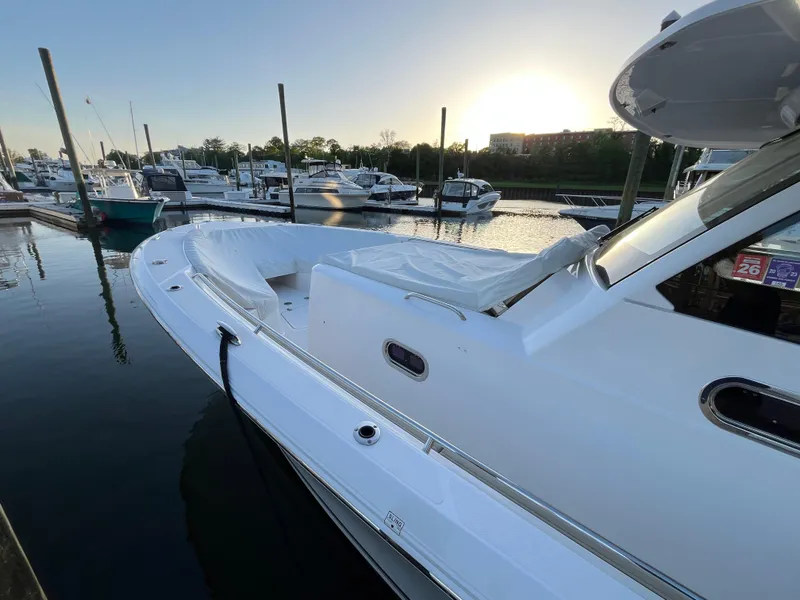 Slide: The Image of 2019 Pursuit S 408 Sport boat docked at marina during sunset. - 16