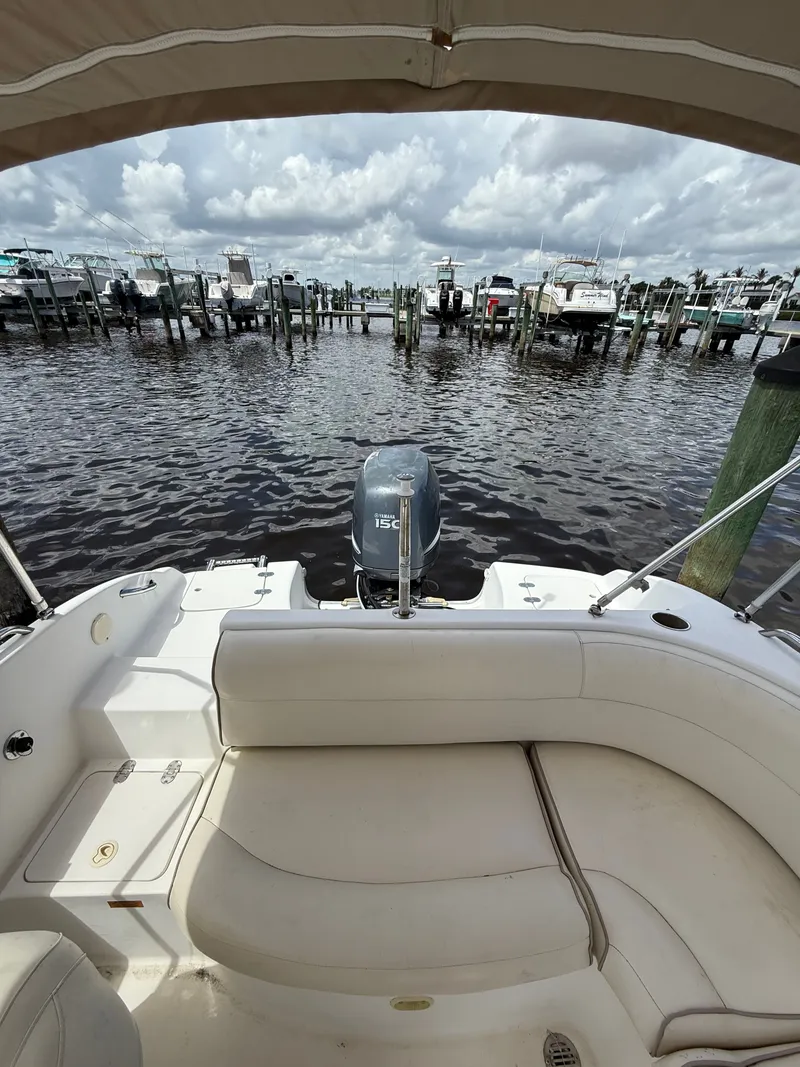 Slide: The Image of 2007 NauticStar 210 Sport Deck boat at dock with motor view. - 12