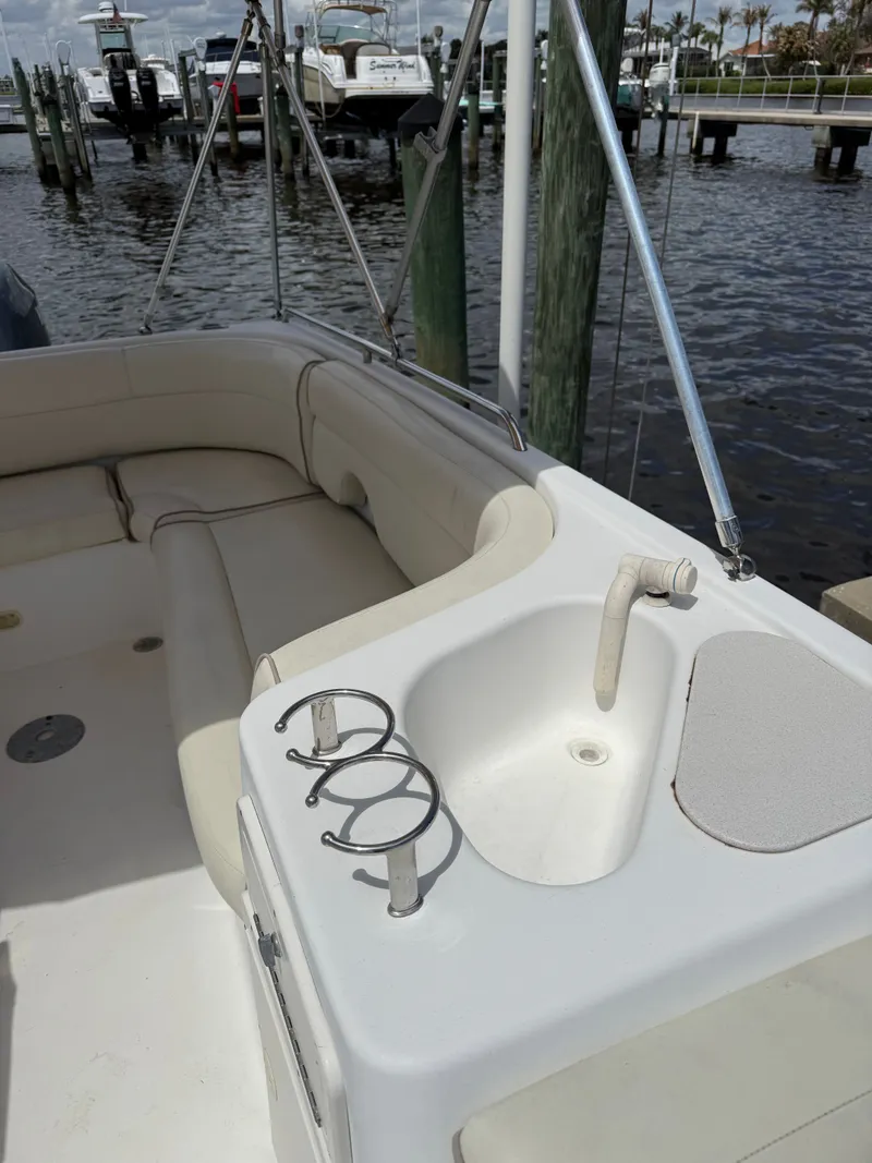 Slide: The Image of 2007 NauticStar 210 Sport Deck with seating and sink at dock. - 3