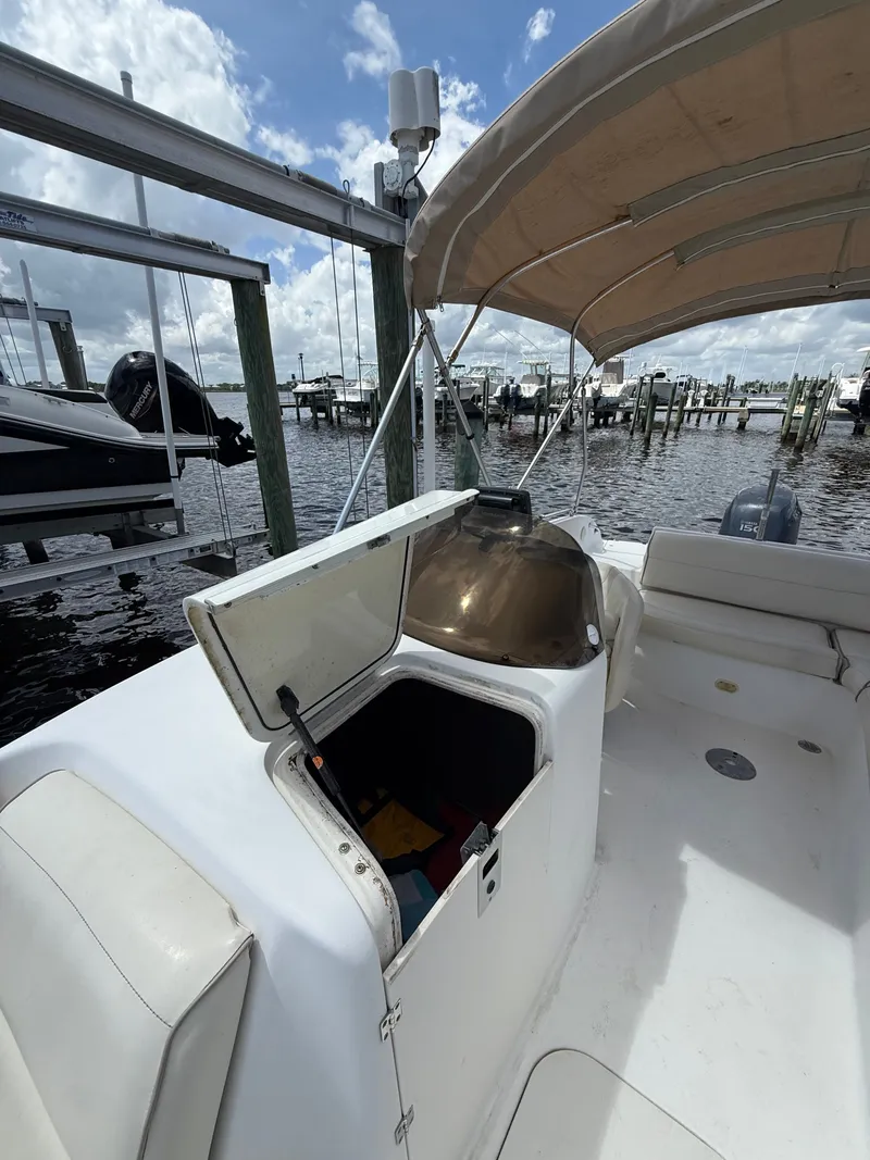 Slide: The Image of 2007 NauticStar 210 Sport Deck with open storage compartment at dock. - 4