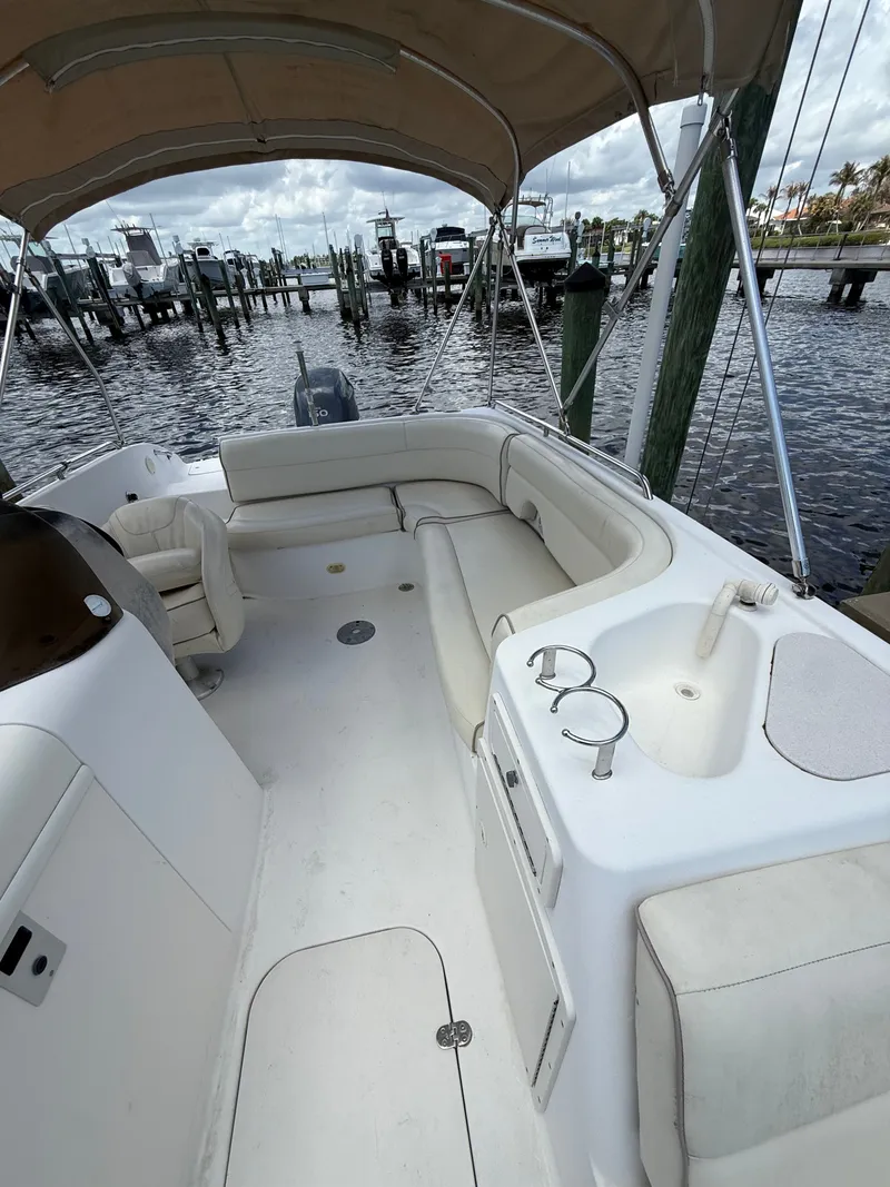 Slide: The Image of 2007 NauticStar 210 Sport Deck with seating area and Bimini top. - 8