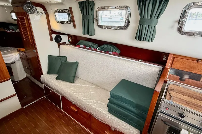 Slide: The Image of Interior of a 1975 Soverel 37 sailboat with cozy seating and wooden accents. - 13