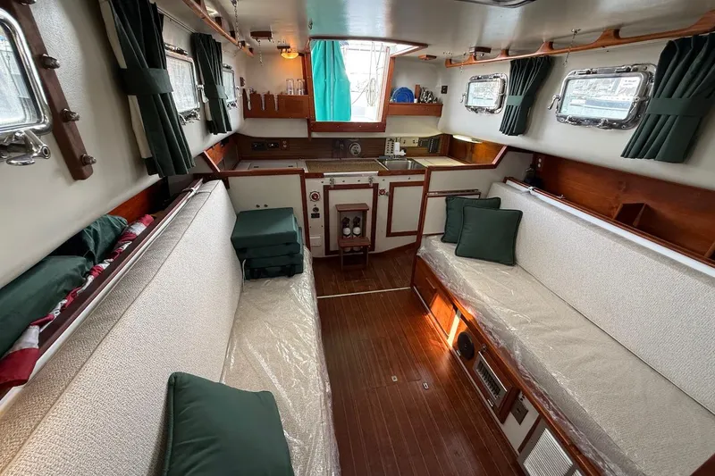 Slide: The Image of Interior of a 1975 Soverel 37 sailboat with cozy seating and wooden finishes. - 14