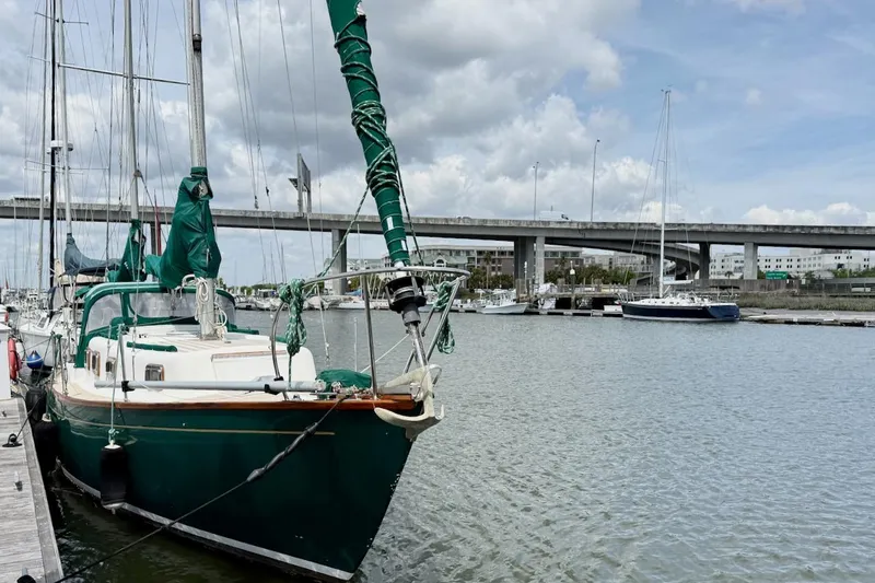 Slide: The Image of Soverel 37 sailboat from 1975 docked in a marina with a bridge in the background. - 2