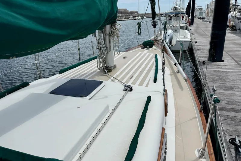 Slide: The Image of Soverel 37 sailboat from 1975 docked at a marina, featuring green sail covers. - 4
