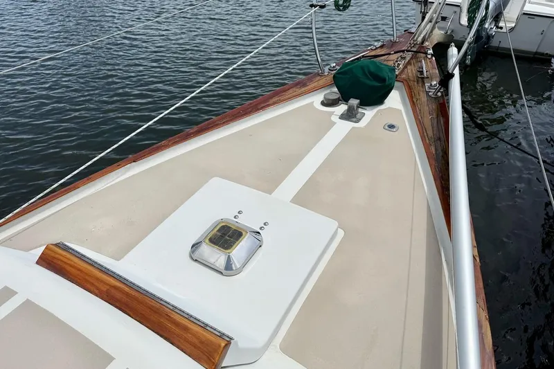Slide: The Image of 1975 Soverel 37 sailboat deck with wooden trim, docked on calm water. - 5