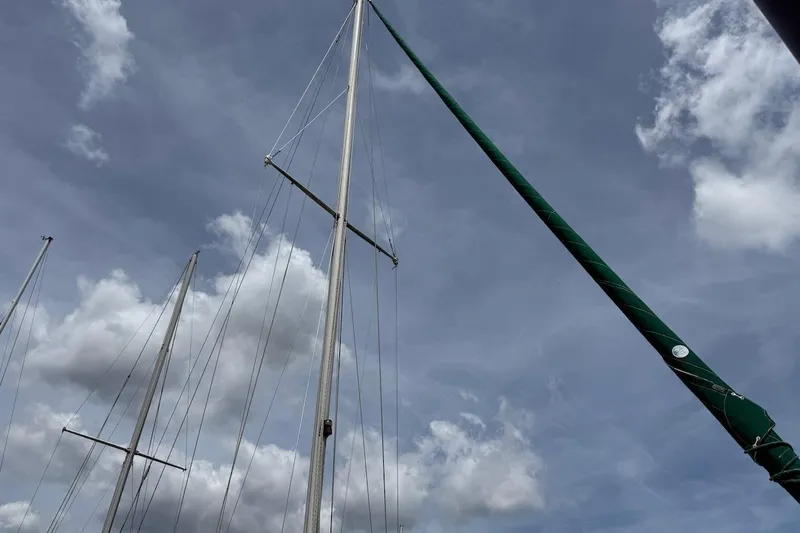 Slide: The Image of Masts of a 1975 Soverel 37 sailboat against a cloudy sky. - 8