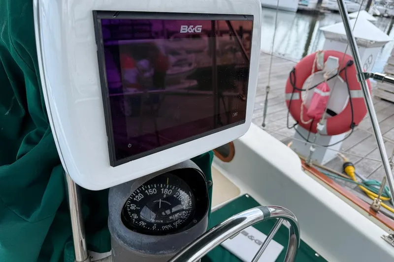 Slide: The Image of Compass and navigation display on a 1975 Soverel 37 sailboat, docked with lifebuoy visible. - 9