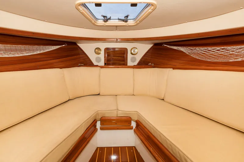 Slide: The Image of Interior of 1997 Hinckley Runabout 29 with beige seating and wooden accents. - 13