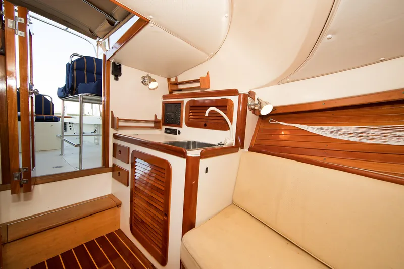Slide: The Image of Interior of a 1997 Hinckley Runabout 29, featuring wooden cabinetry and seating. - 4
