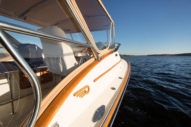 Slide: The Image of Hinckley Runabout 29 boat cruising on a sunny day, showcasing elegant design and craftsmanship. - 6