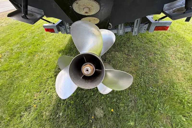 Slide: The Image of Propeller of a 2002 Sea Ray 240 Sundancer boat on grass. - 10