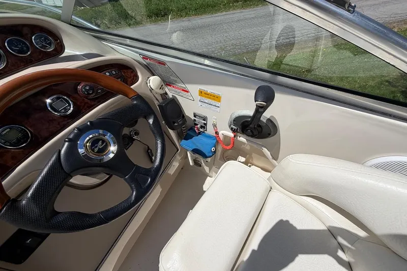 Slide: The Image of Interior view of 2002 Sea Ray 240 Sundancer boat cockpit with steering wheel and controls. - 16
