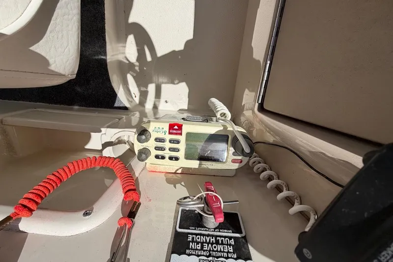 Slide: The Image of VHF radio and safety equipment on 2002 Sea Ray 240 Sundancer boat. - 17