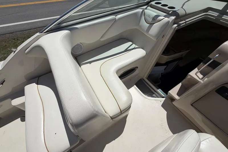 Slide: The Image of 2002 Sea Ray 240 Sundancer interior with white seating and cup holders. - 20