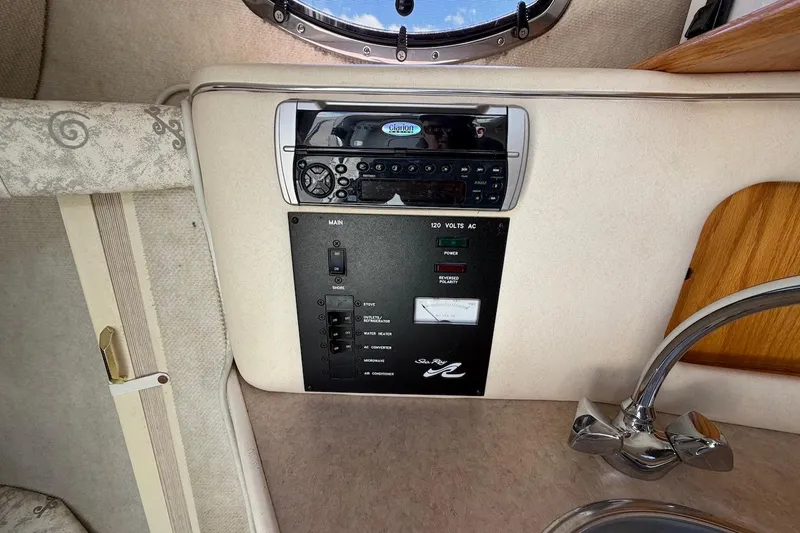 Slide: The Image of Control panel and stereo system in 2002 Sea Ray 240 Sundancer boat interior. - 27