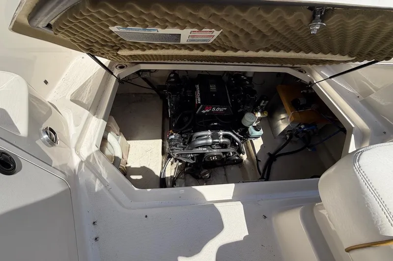 Slide: The Image of Engine compartment of a 2002 Sea Ray 240 Sundancer boat, showcasing the MerCruiser 5.0L engine. - 31