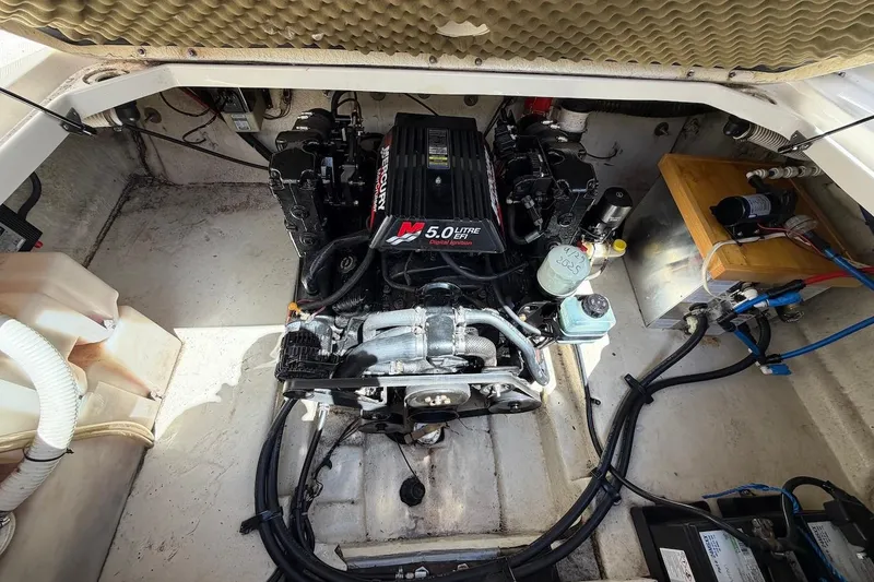 Slide: The Image of Engine compartment of a 2002 Sea Ray 240 Sundancer with a 5.0L MerCruiser engine. - 32