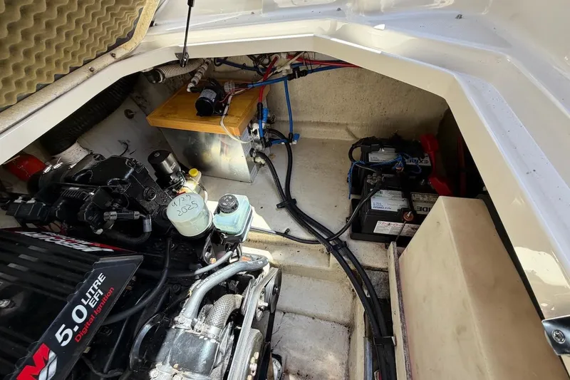 Slide: The Image of Engine compartment of a 2002 Sea Ray 240 Sundancer with visible components and wiring. - 35