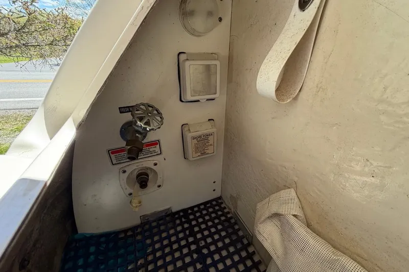 Slide: The Image of 2002 Sea Ray 240 Sundancer boat utility area with water and power connections. - 36