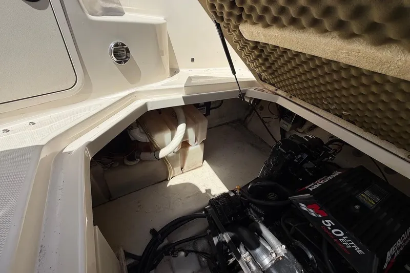 Slide: The Image of Engine compartment of a 2002 Sea Ray 240 Sundancer boat, featuring a MerCruiser 5.0L engine. - 37