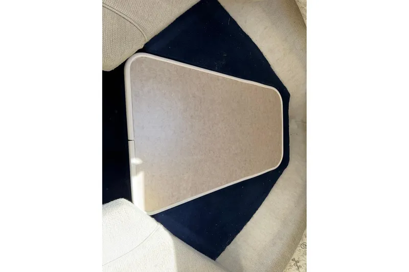 Slide: The Image of Interior view of a 2002 Sea Ray 240 Sundancer boat, featuring a table setup. - 38
