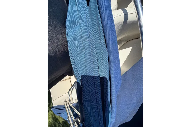 Slide: The Image of Blue fabric and boat railing on a 2002 Sea Ray 240 Sundancer. - 44
