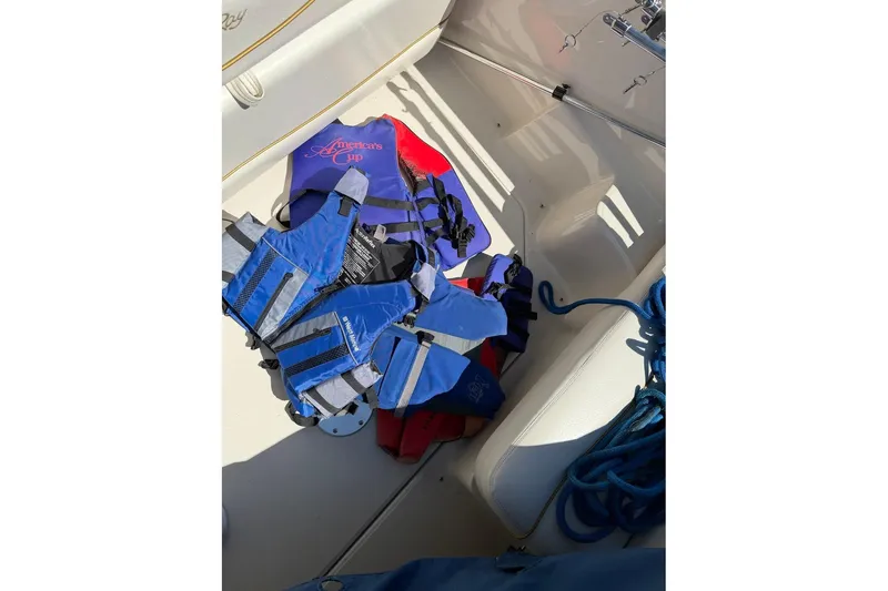 Slide: The Image of Life jackets on a 2002 Sea Ray 240 Sundancer boat deck, with blue ropes nearby. - 45