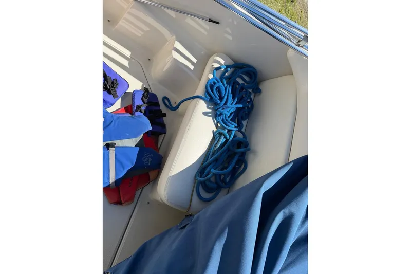 Slide: The Image of Blue rope and life jackets on a 2002 Sea Ray 240 Sundancer boat seat. - 46