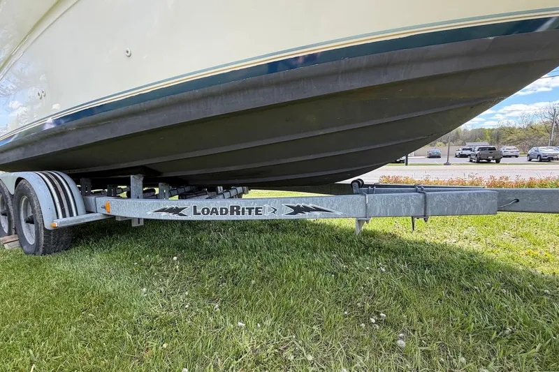 Slide: The Image of 2002 Sea Ray 240 Sundancer on Load Rite trailer, parked on grass. - 7