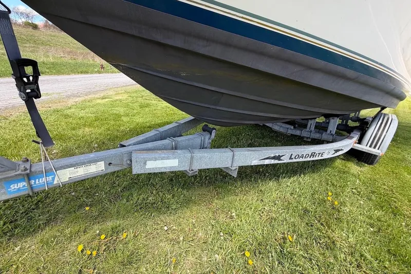 Slide: The Image of 2002 Sea Ray 240 Sundancer boat on Load Rite trailer, parked on grass. - 8