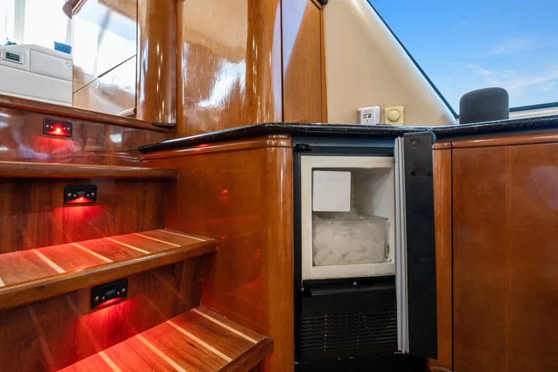 Slide: The Image of 2007 Meridian 490 Pilothouse interior with wooden stairs and built-in ice maker. - 22