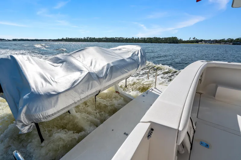 Slide: The Image of 2007 Meridian 490 Pilothouse boat with covered equipment on deck, cruising on open water. - 58