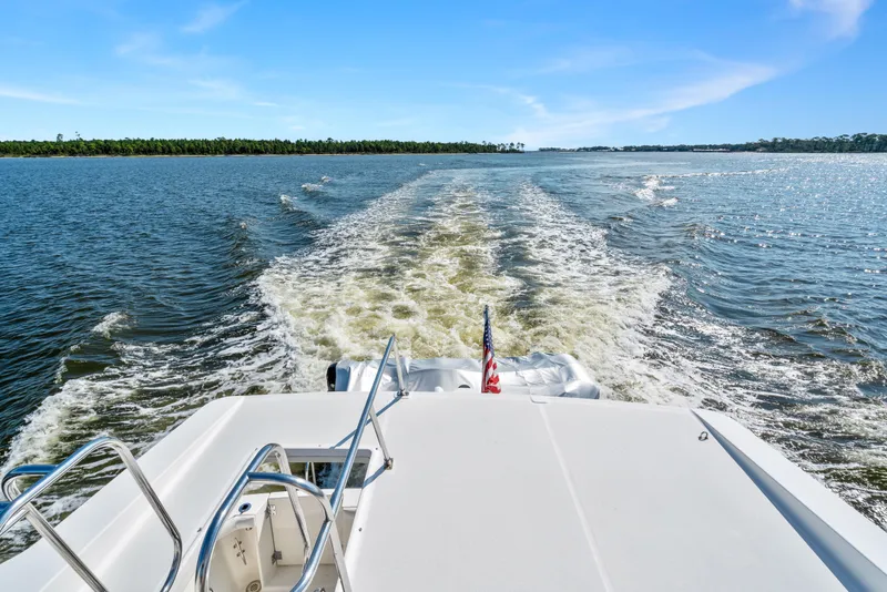 Slide: The Image of 2007 Meridian 490 Pilothouse cruising on open water, leaving a wake behind. - 59
