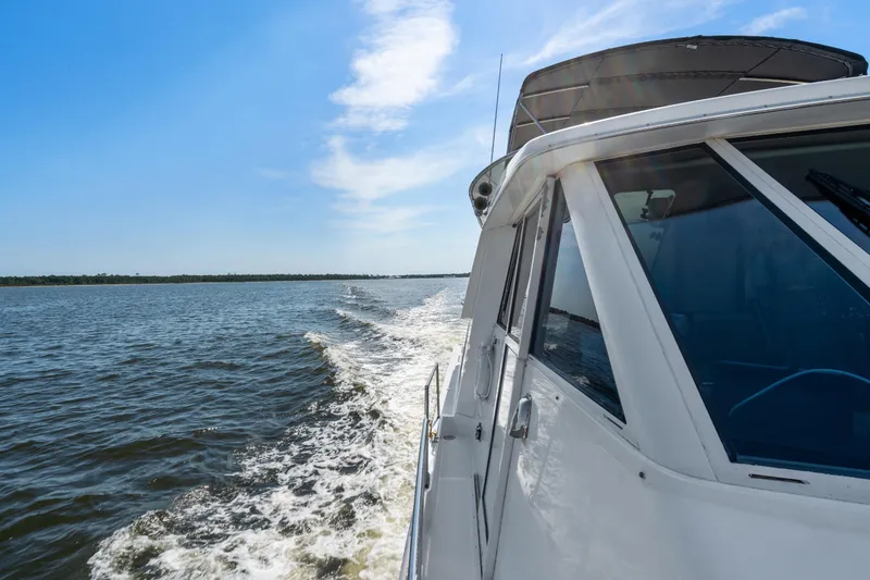 Slide: The Image of 2007 Meridian 490 Pilothouse cruising on open water under clear blue sky. - 64