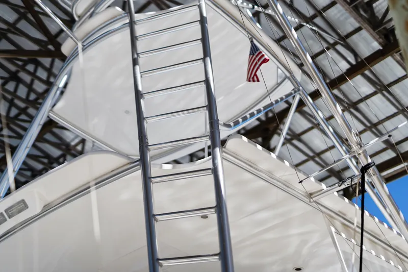 Slide: The Image of 2007 Viking 56 Convertible yacht ladder with American flag under a metal roof. - 58