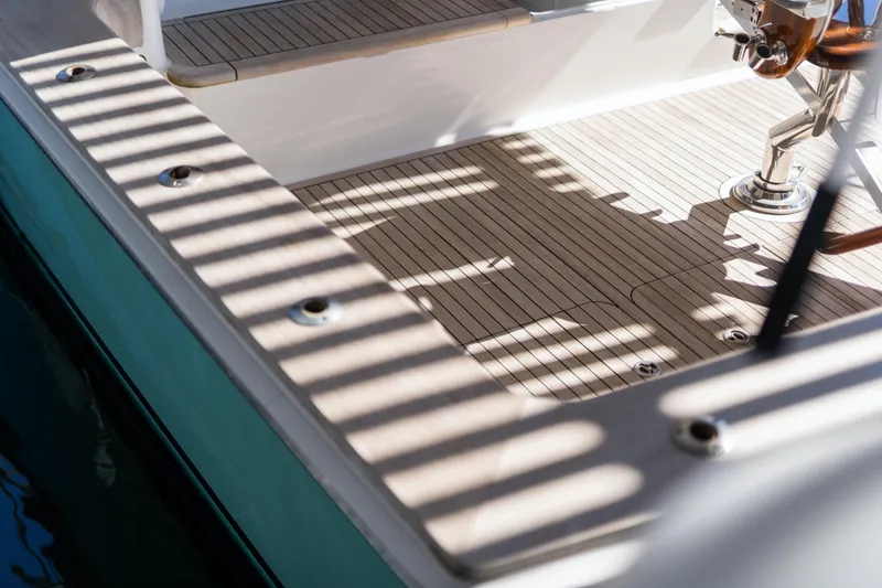 Slide: The Image of Teak deck of 2007 Viking 56 Convertible yacht with striped shadows. - 60