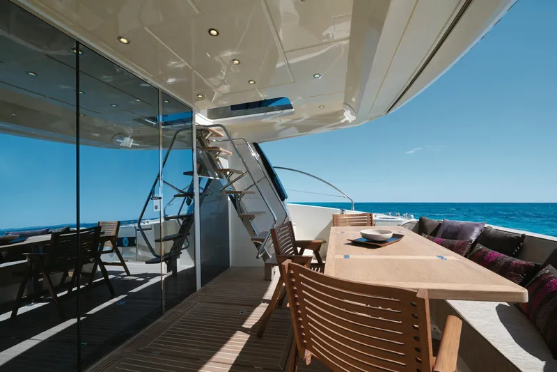Slide: The Image of Luxury yacht Beneteau Monte Carlo MC6 2017, featuring elegant outdoor dining area with ocean view. - 14