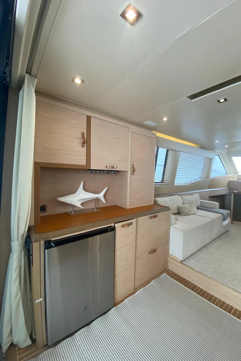 Slide: The Image of Interior of 2017 Beneteau Monte Carlo MC6 yacht, featuring modern cabinetry and seating area. - 20
