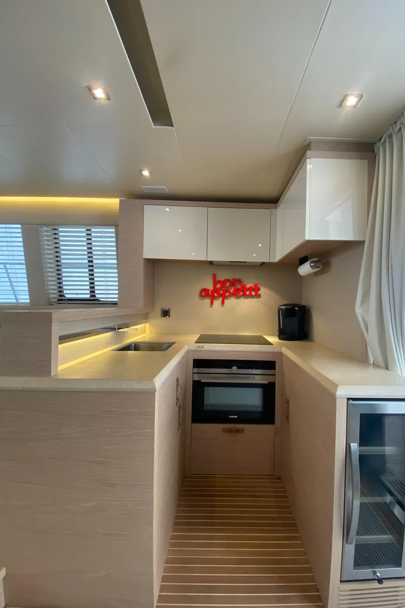 Slide: The Image of Modern kitchen interior of 2017 Beneteau Monte Carlo MC6 yacht with sleek cabinetry and appliances. - 26