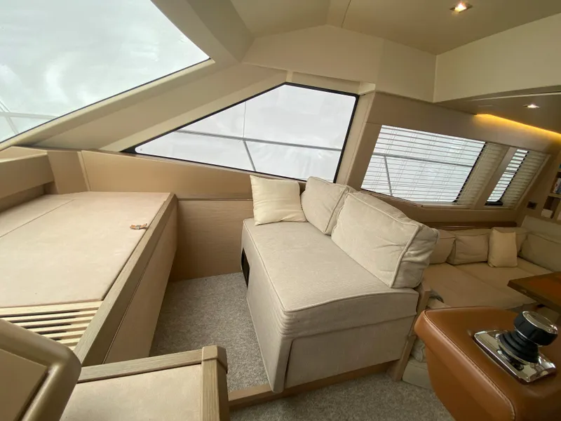 Slide: The Image of Luxurious interior of 2017 Beneteau Monte Carlo MC6 yacht with beige seating and large windows. - 32