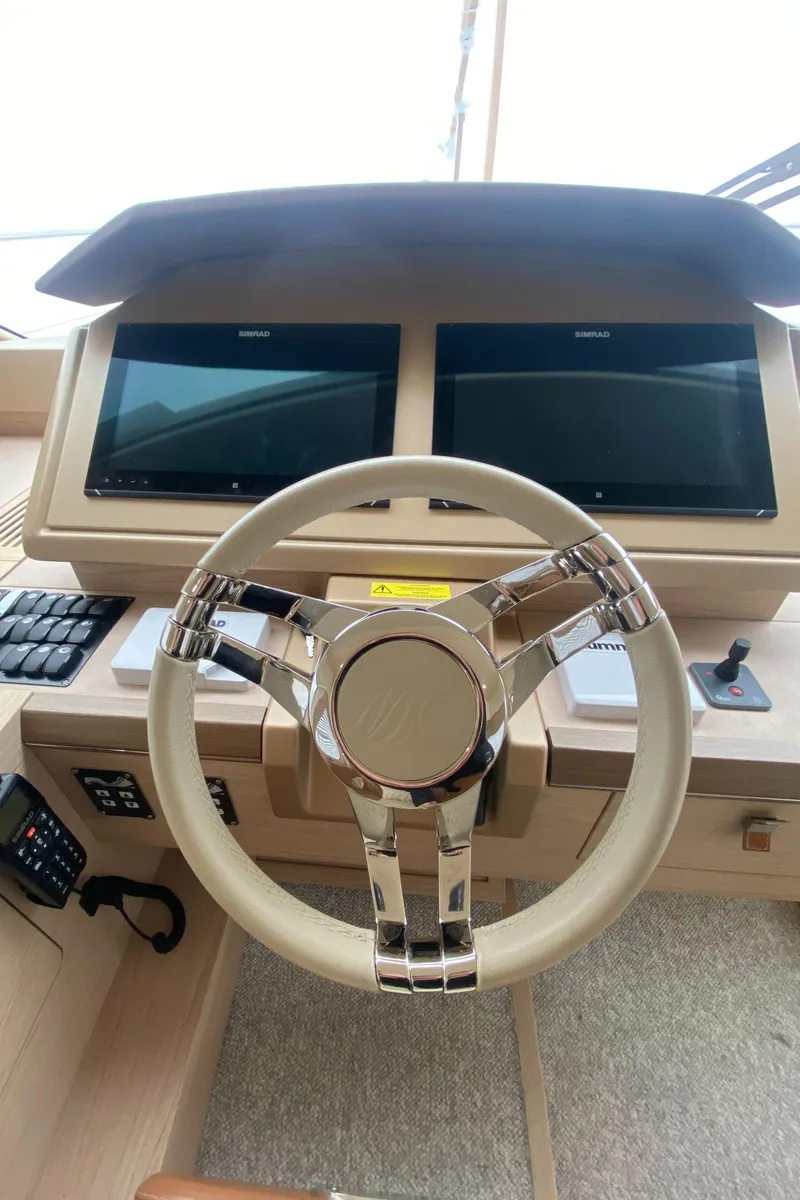 Slide: The Image of Steering wheel and dual screens of 2017 Beneteau Monte Carlo MC6 yacht cockpit. - 34