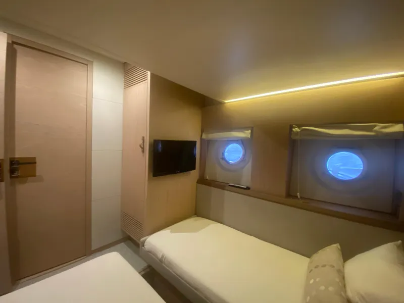 Slide: The Image of 2017 Beneteau Monte Carlo MC6 cabin interior with twin beds and porthole windows. - 39