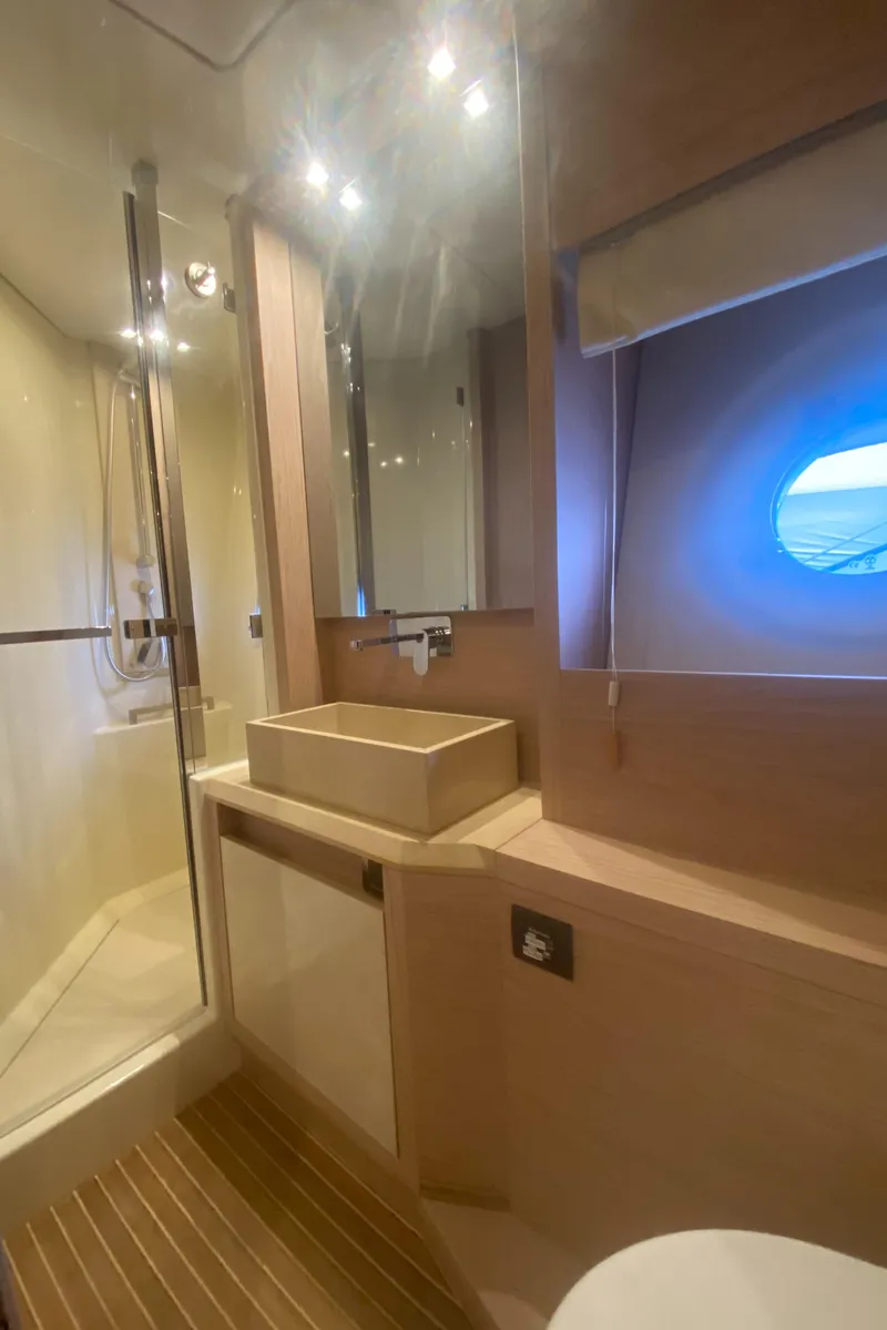 Slide: The Image of Luxurious bathroom in 2017 Beneteau Monte Carlo MC6 yacht with modern fixtures and porthole window. - 40