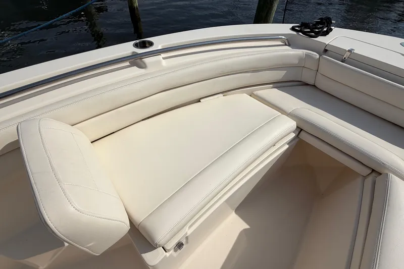 Slide: The Image of 2018 Grady-White Fisherman 236 boat with white cushioned seating and storage compartment. - 10
