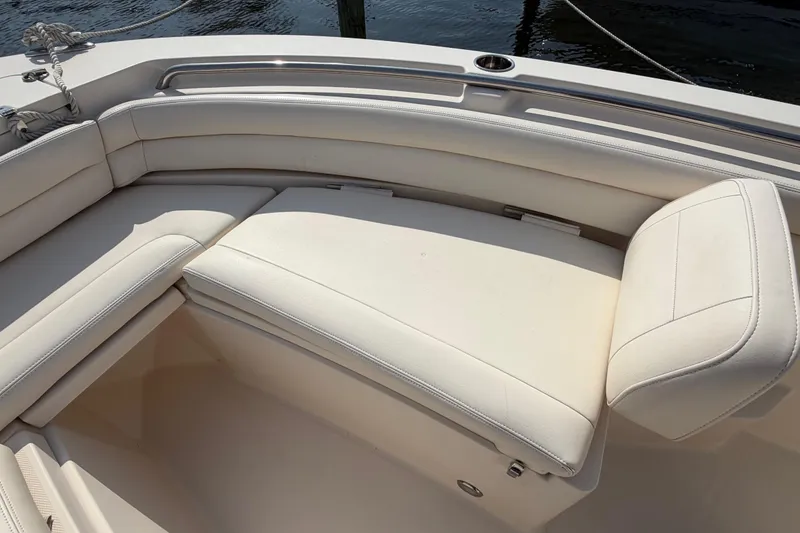 Slide: The Image of 2018 Grady-White Fisherman 236 boat with white cushioned seating, docked by water. - 11