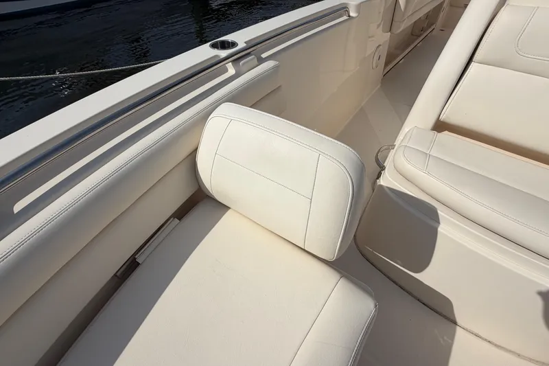 Slide: The Image of 2018 Grady-White Fisherman 236 boat interior with white cushioned seating. - 12